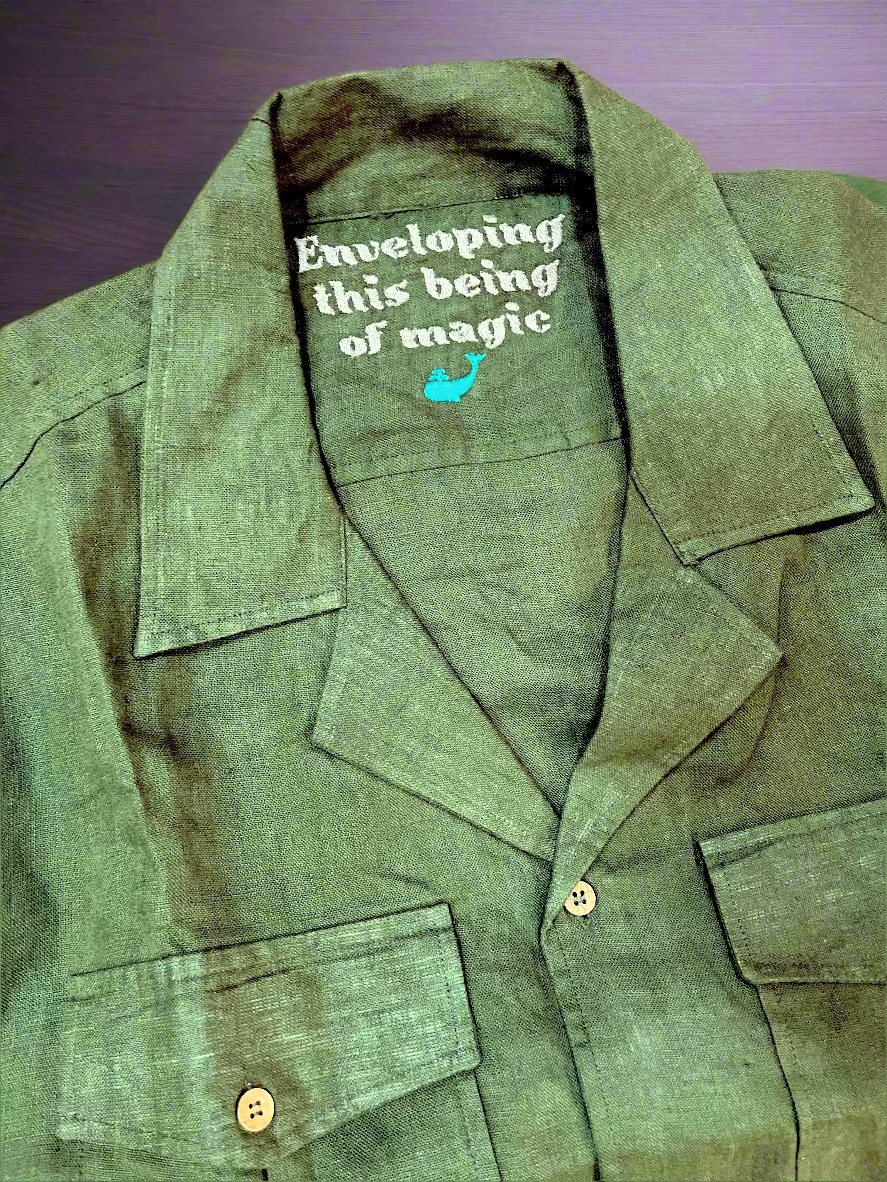 Green jacket with text and logo on a pink background