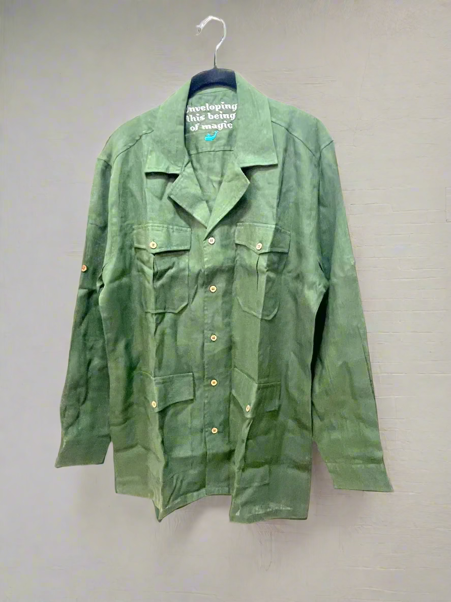 Green jacket on a hanger against a white background